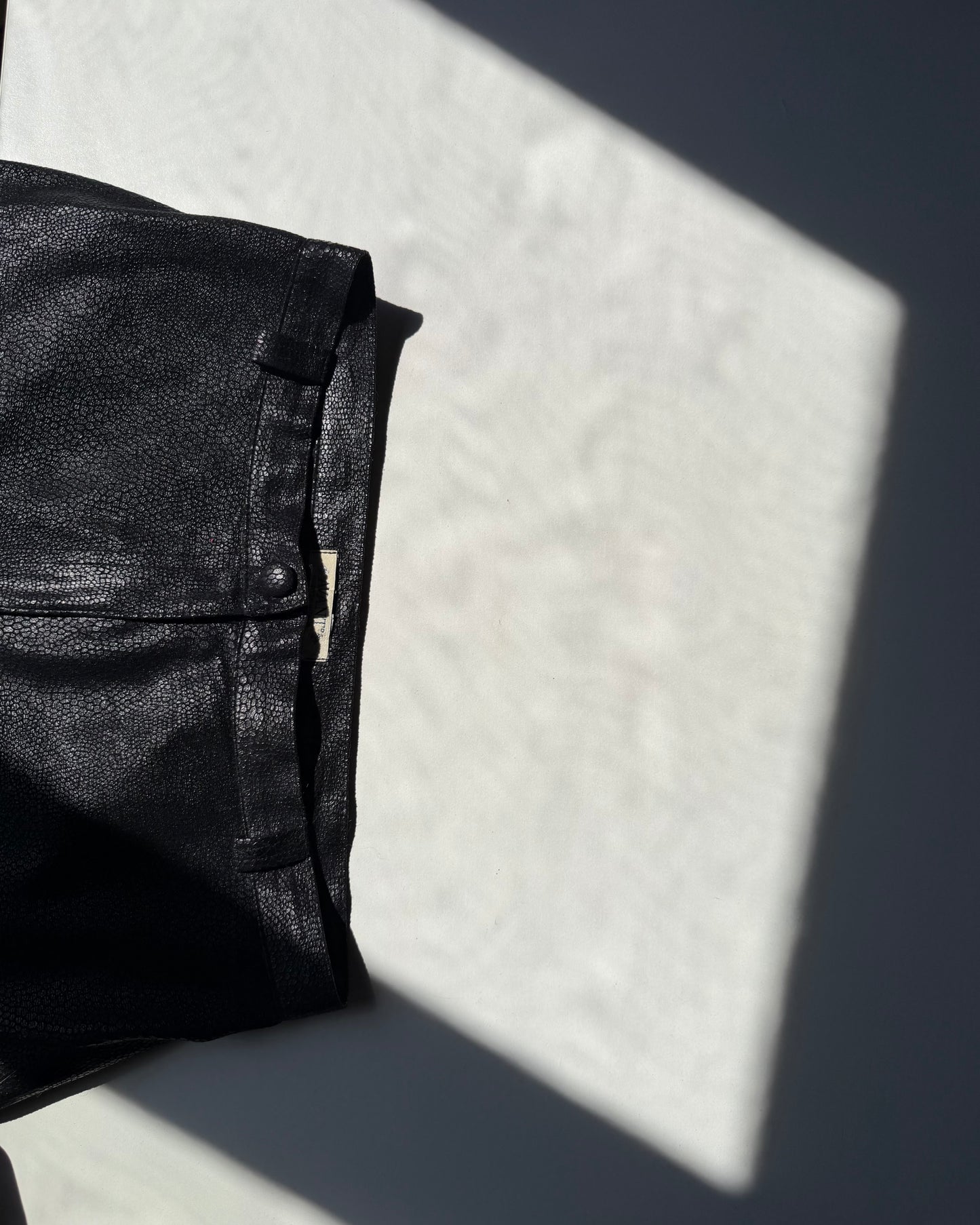 Black faux leather trousers